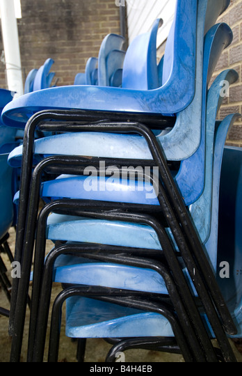 stack-of-blue-plastic-chairs-B4H4EB.jpg