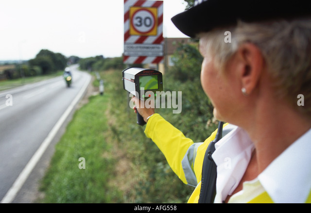 a-police-woman-raodside-with-a-hand-held