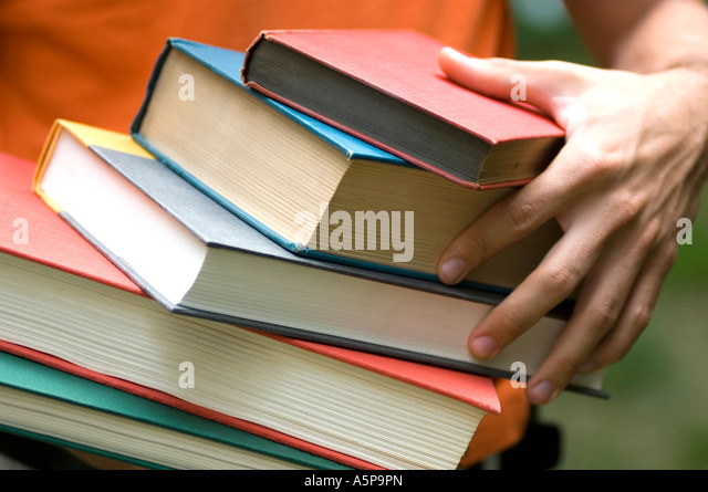 hands-holding-many-school-books-and-text
