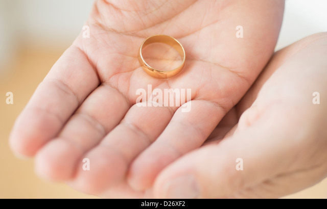hand-holding-wedding-ring-d26xf2.jpg