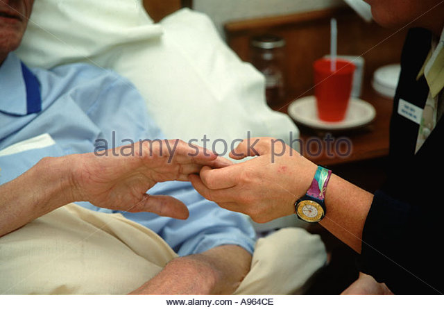 hospice-worker-holding-elderly-man-s-han