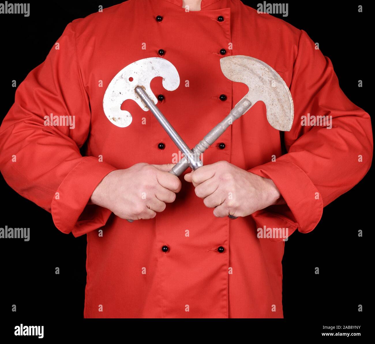 chef in red textile uniform holding old metal knives for meat and ...