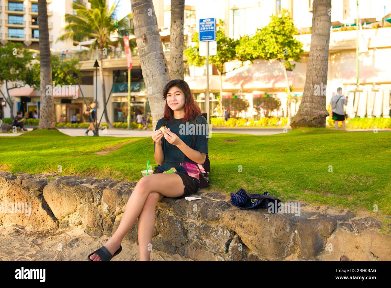 Biracial Asian Caucasian Teenage Girl Tourist Relaxing And Sitting On