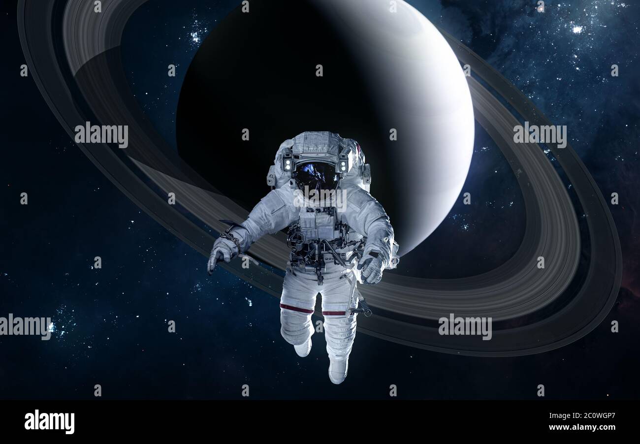 Astronaut on background of Saturn. Solar system Stock Photo - Alamy