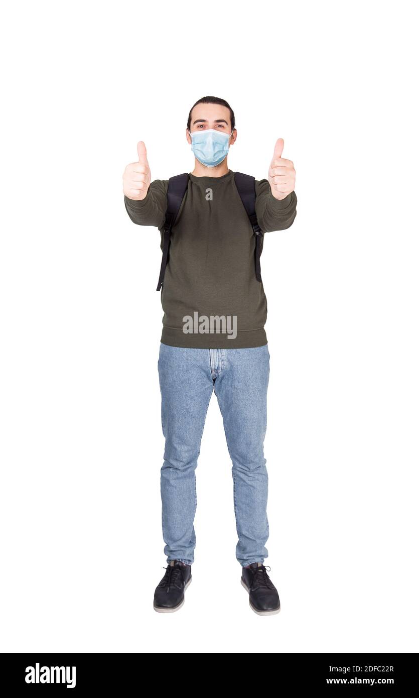 Full length portrait of cautious young man wearing face mask as ...