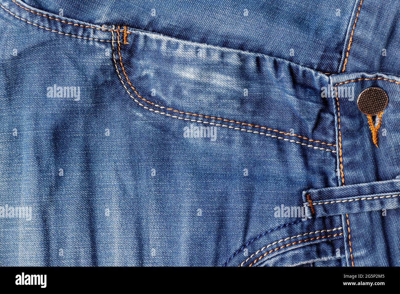 Blue jeans fabric background texture. Distressed denim with seams ...