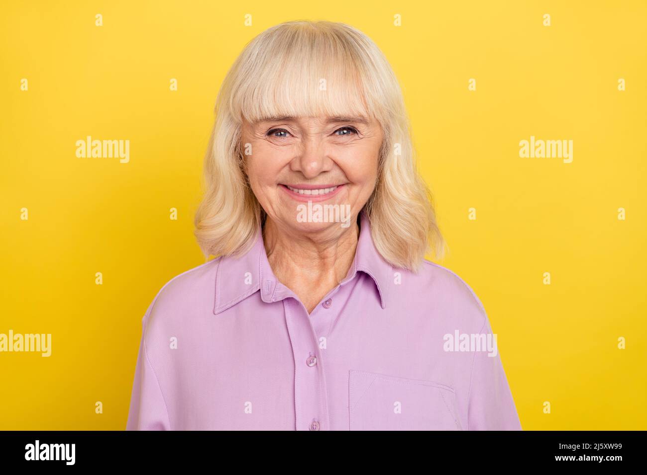 Portrait Of Attractive Cheerful Grey Haired Granny Wearing Violet Shirt
