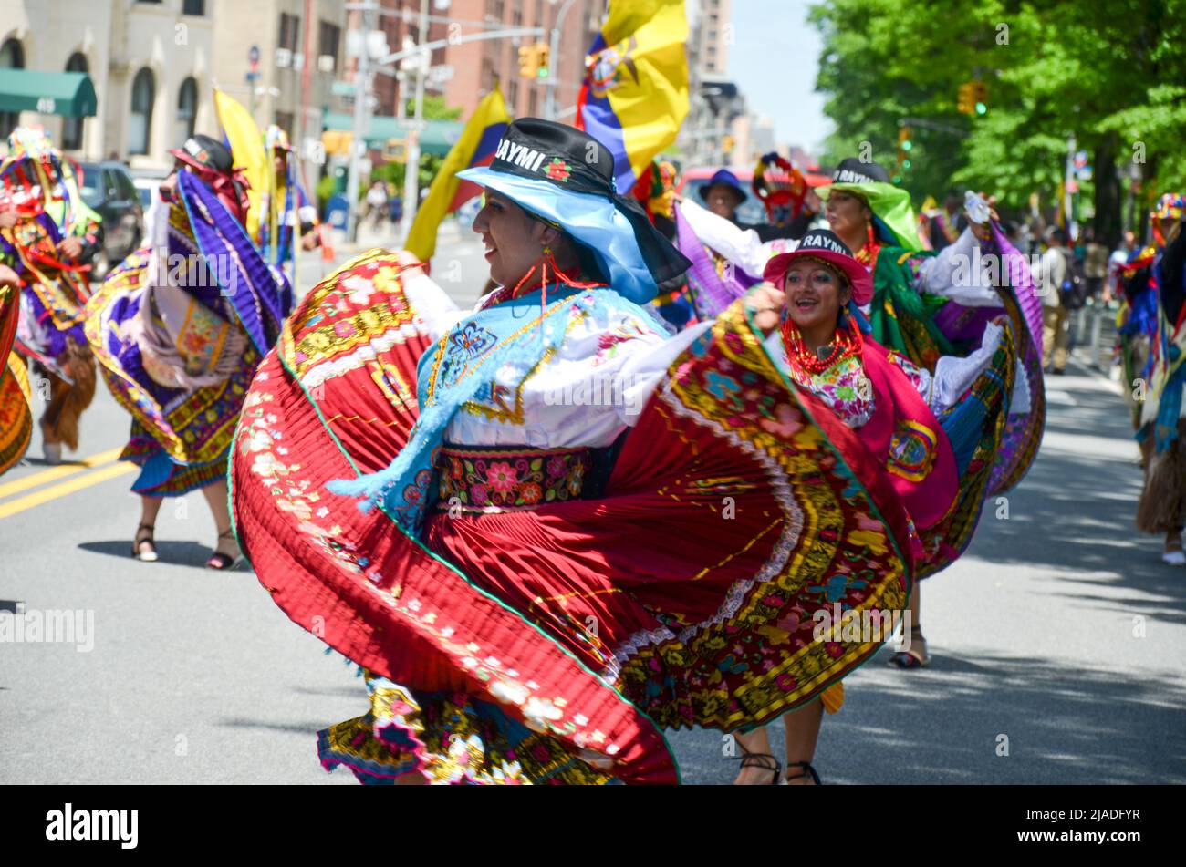 Girls are seen dancing with traditional Ecuadorian outfits during the