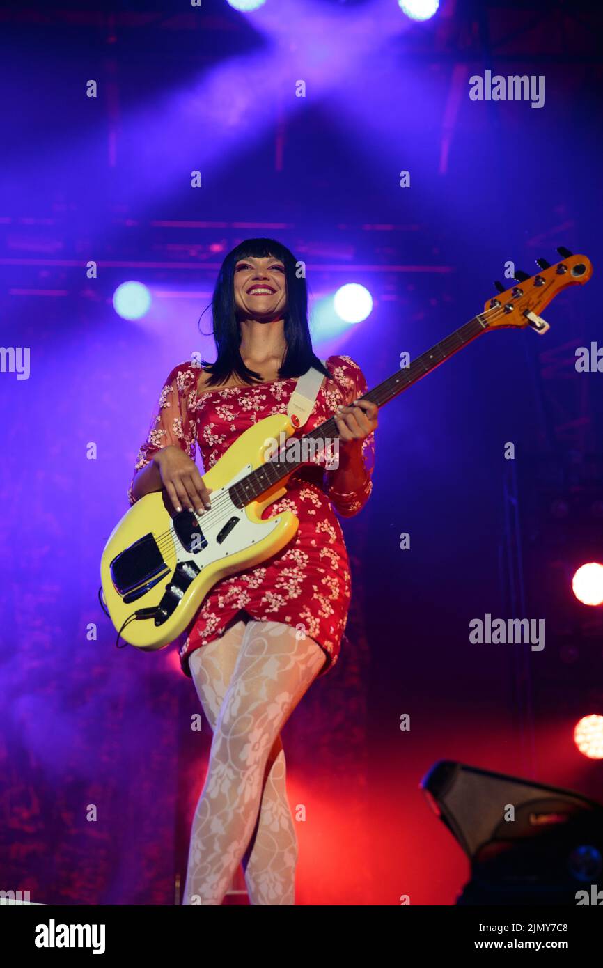 Bassist Laura Lee Of Khruangbin On Stage Wearing A Red Floral Mini