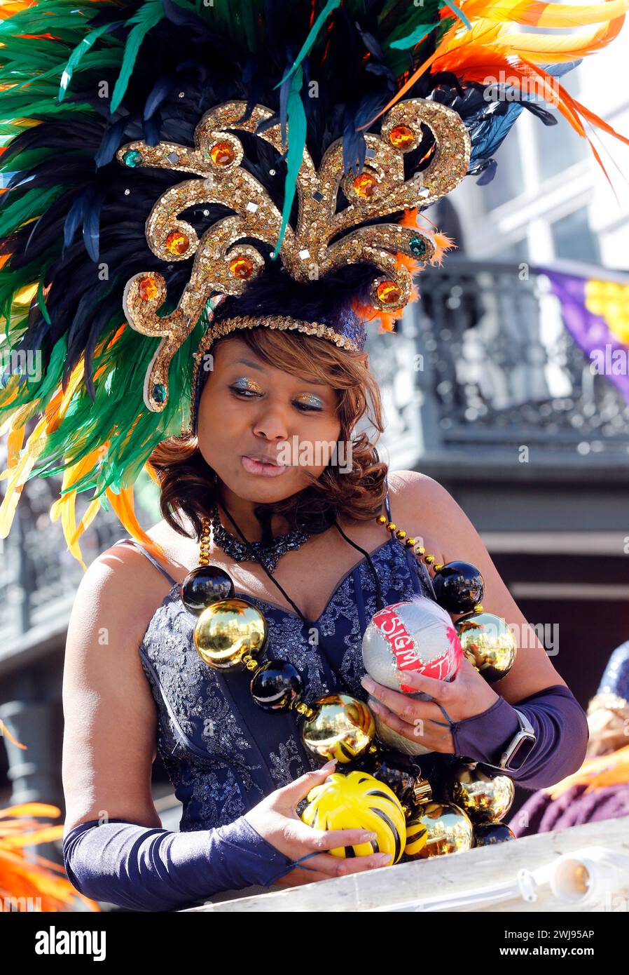 A rider in the Zulu parade holds a coveted coconut in New Orleans on