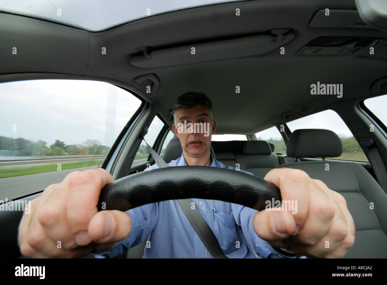 Front View Of A Man Driving A Car Along Uk Motorway Stock Photo Alamy