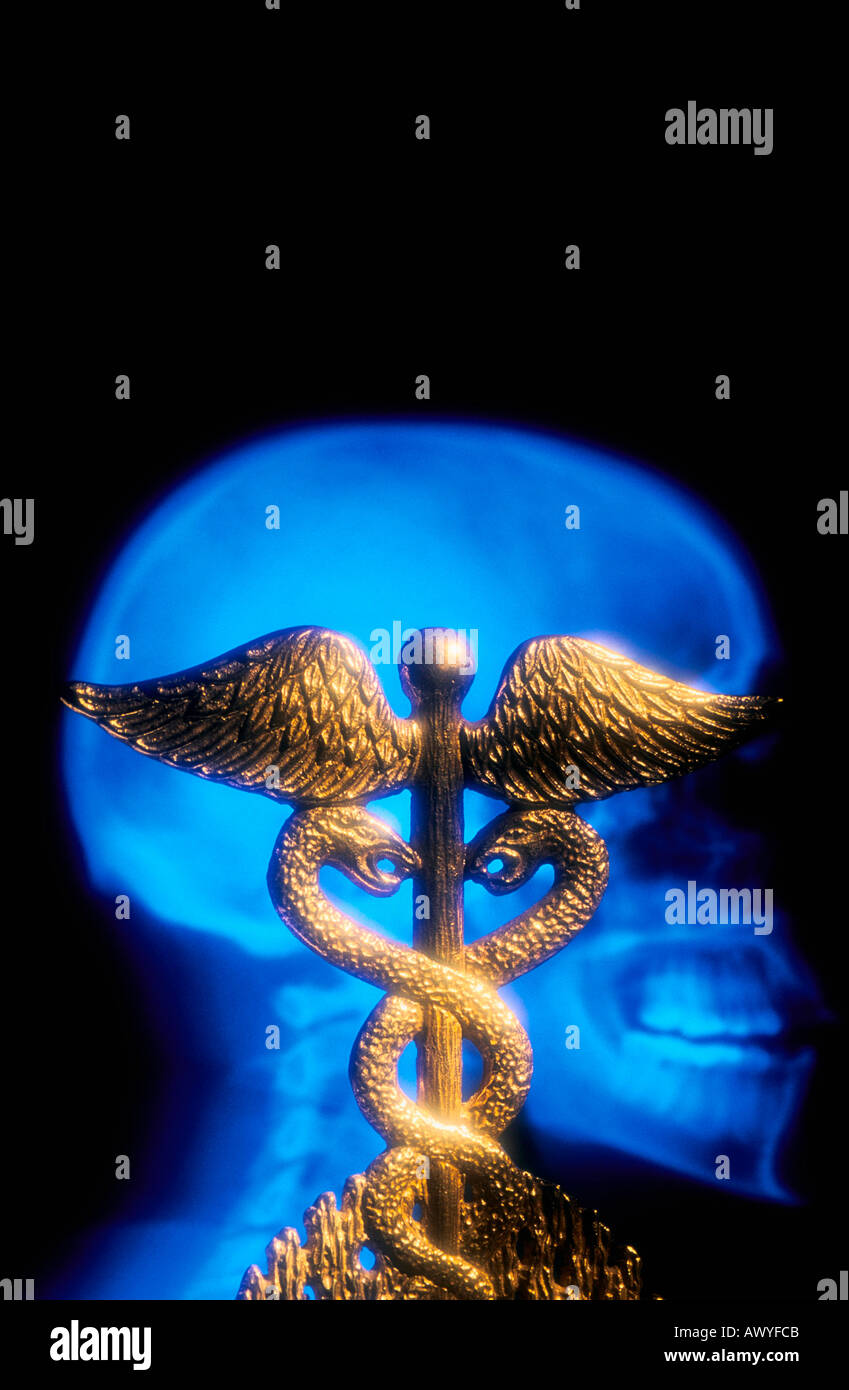 A brass medical caduceus and a skull x ray Stock Photo - Alamy
