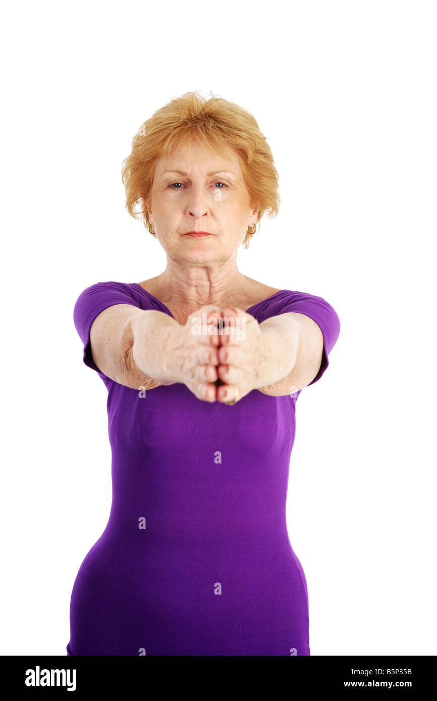 A Senior Lady In Her Seventies Concentrating As She Begins Her Yoga Exercise Routine Isolated On
