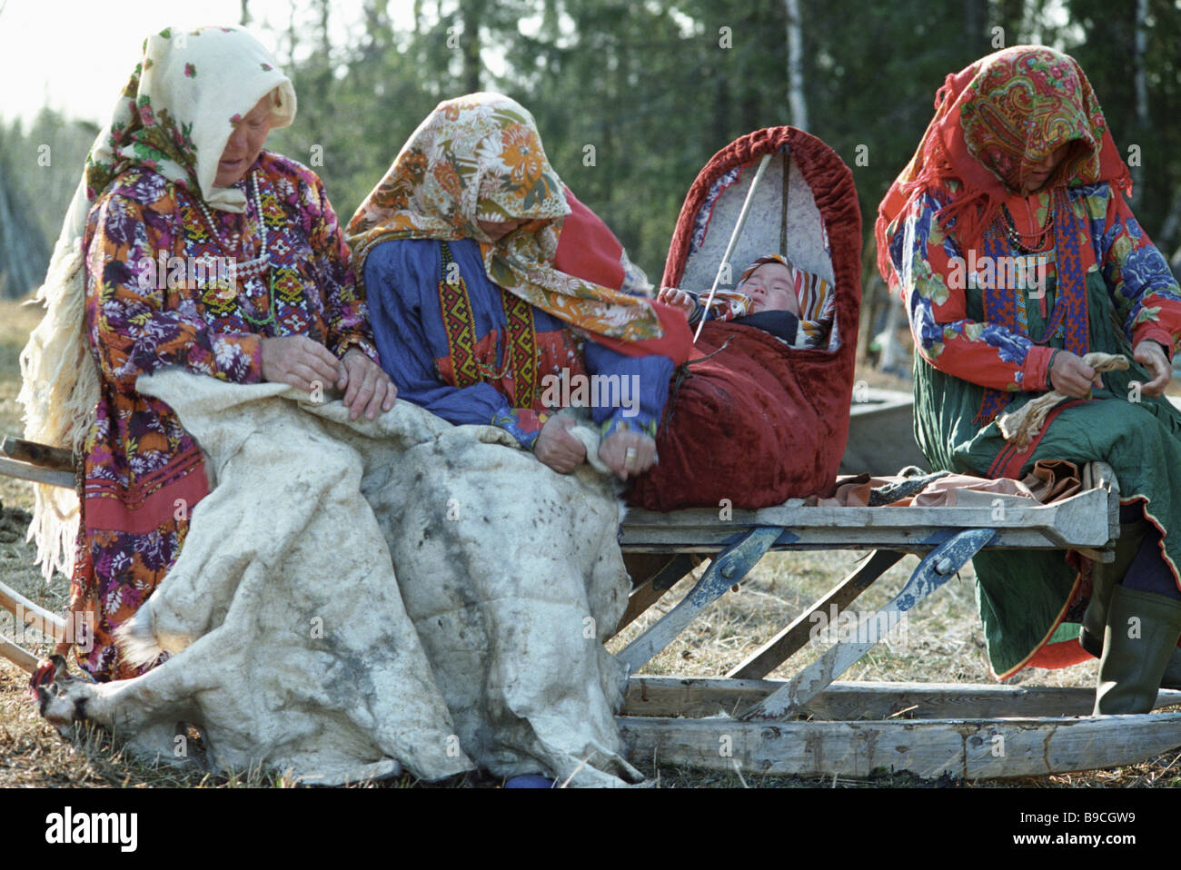Khanty women making clothing of deerskin Stock Photo - Alamy