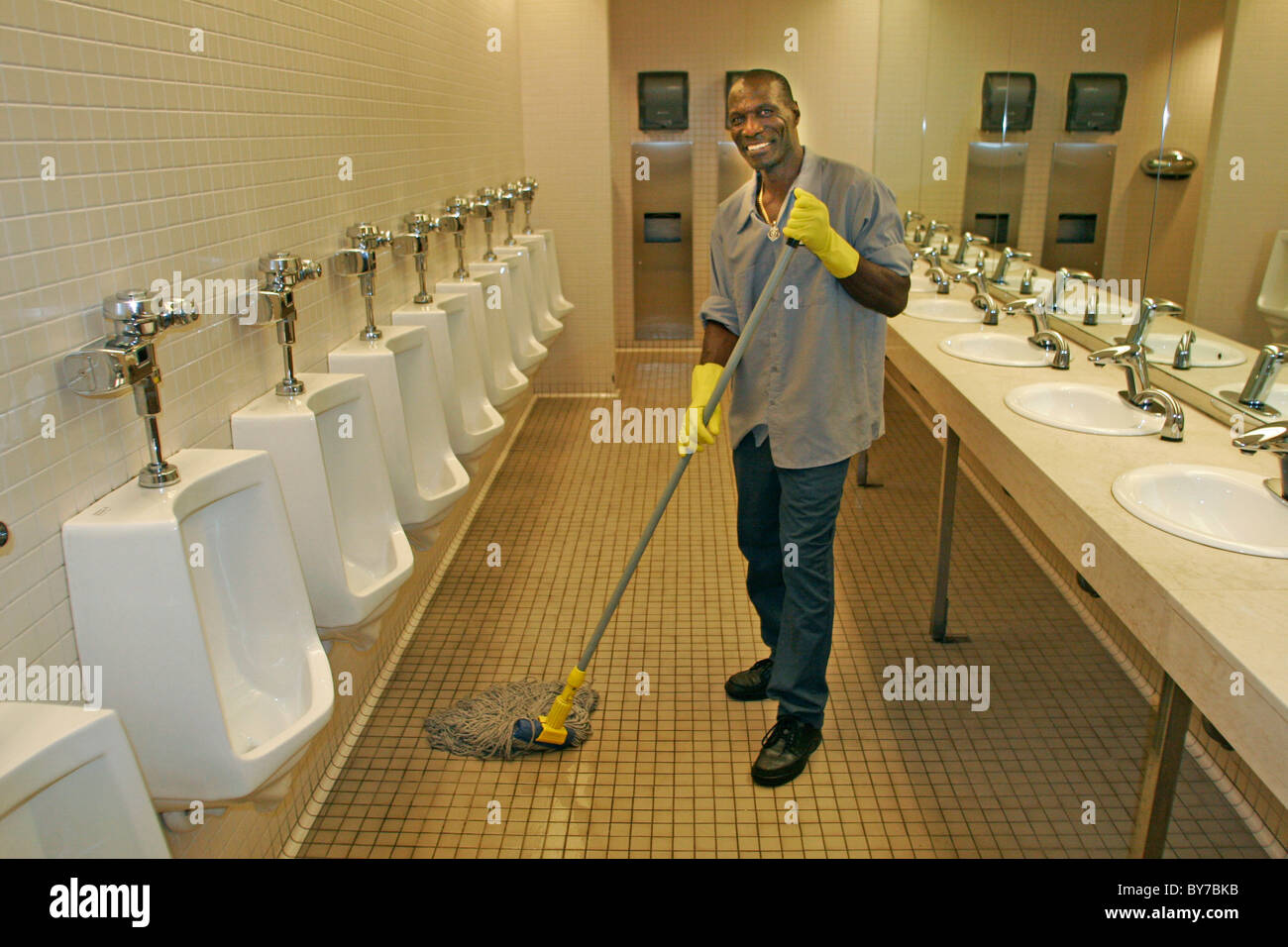 Janitor Cleaning Mens Room Stock Photo Alamy