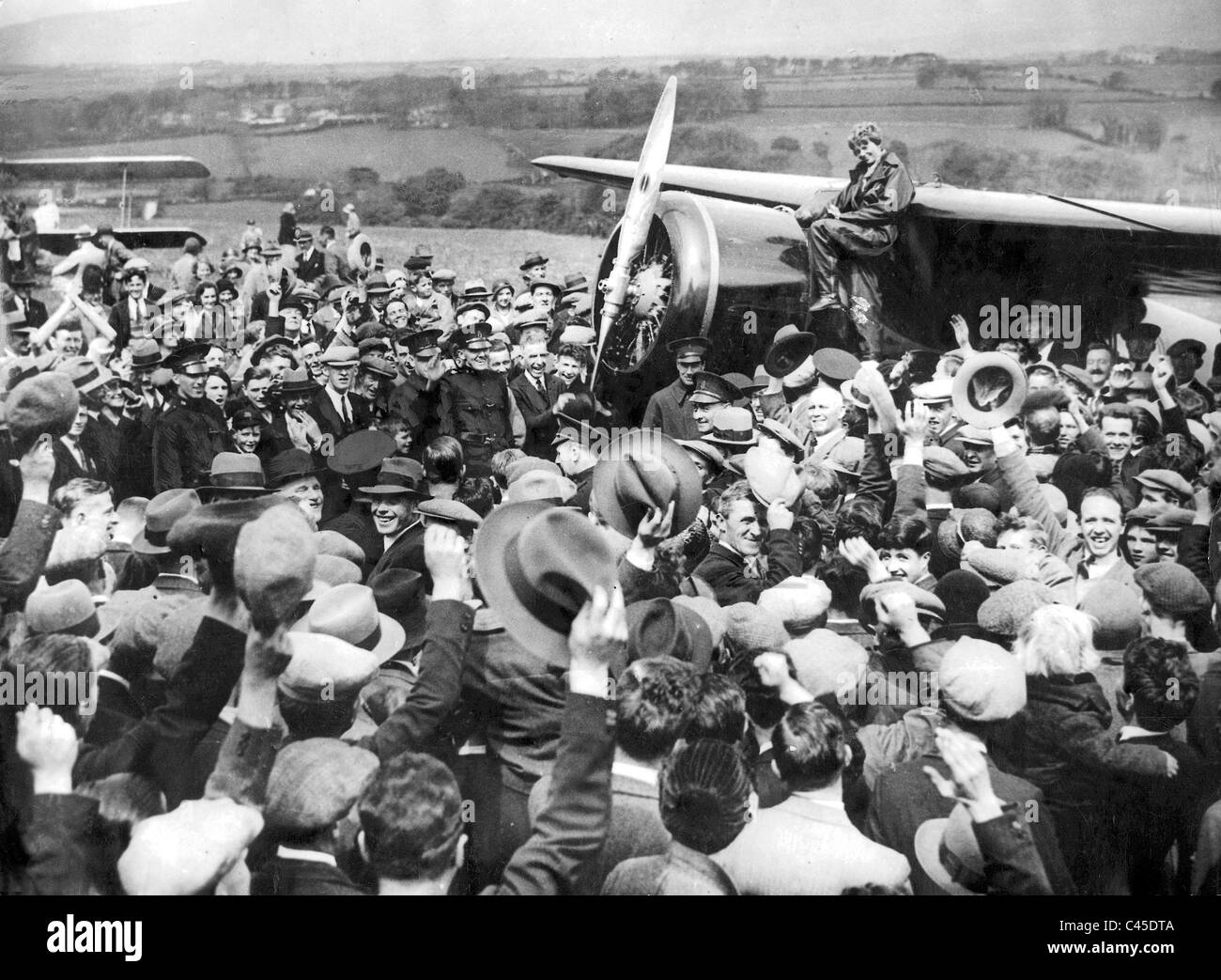 Amelia Earhart is surrounded by onlookers after her second Atlantic ...