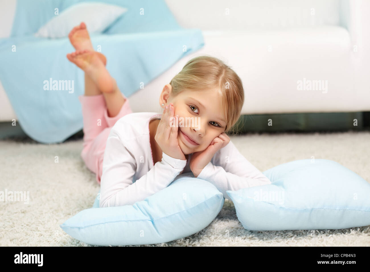 Portrait of lovely girl lying on the floor at home Stock Photo - Alamy