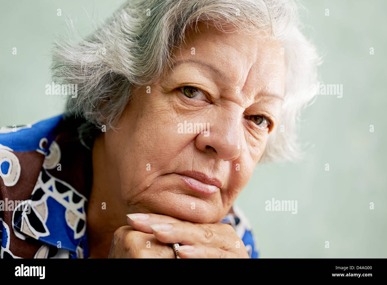 People And Emotions Portrait Of Depressed Senior Hispanic Woman With White Hair Looking At