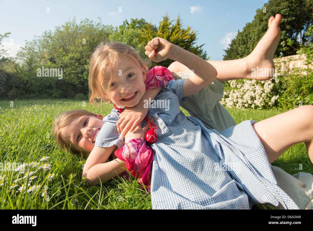 Girls playing together in grassy field Stock Photo - Alamy
