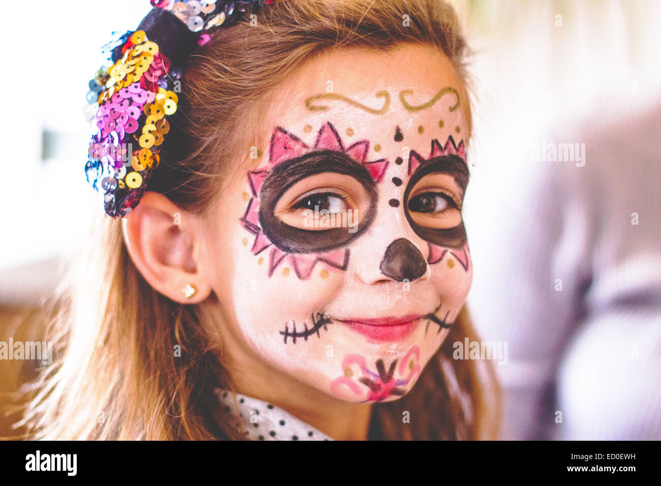 Portrait of a smiling girl with skull face paint Stock Photo - Alamy