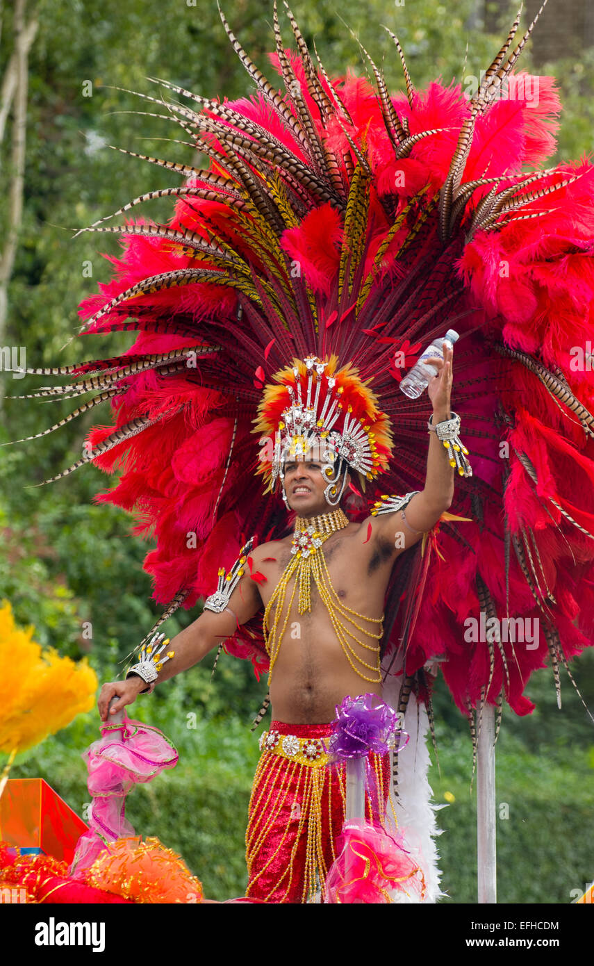 Male Carnival Performer Wearing An Elaborate Headdress Of Red Feathers