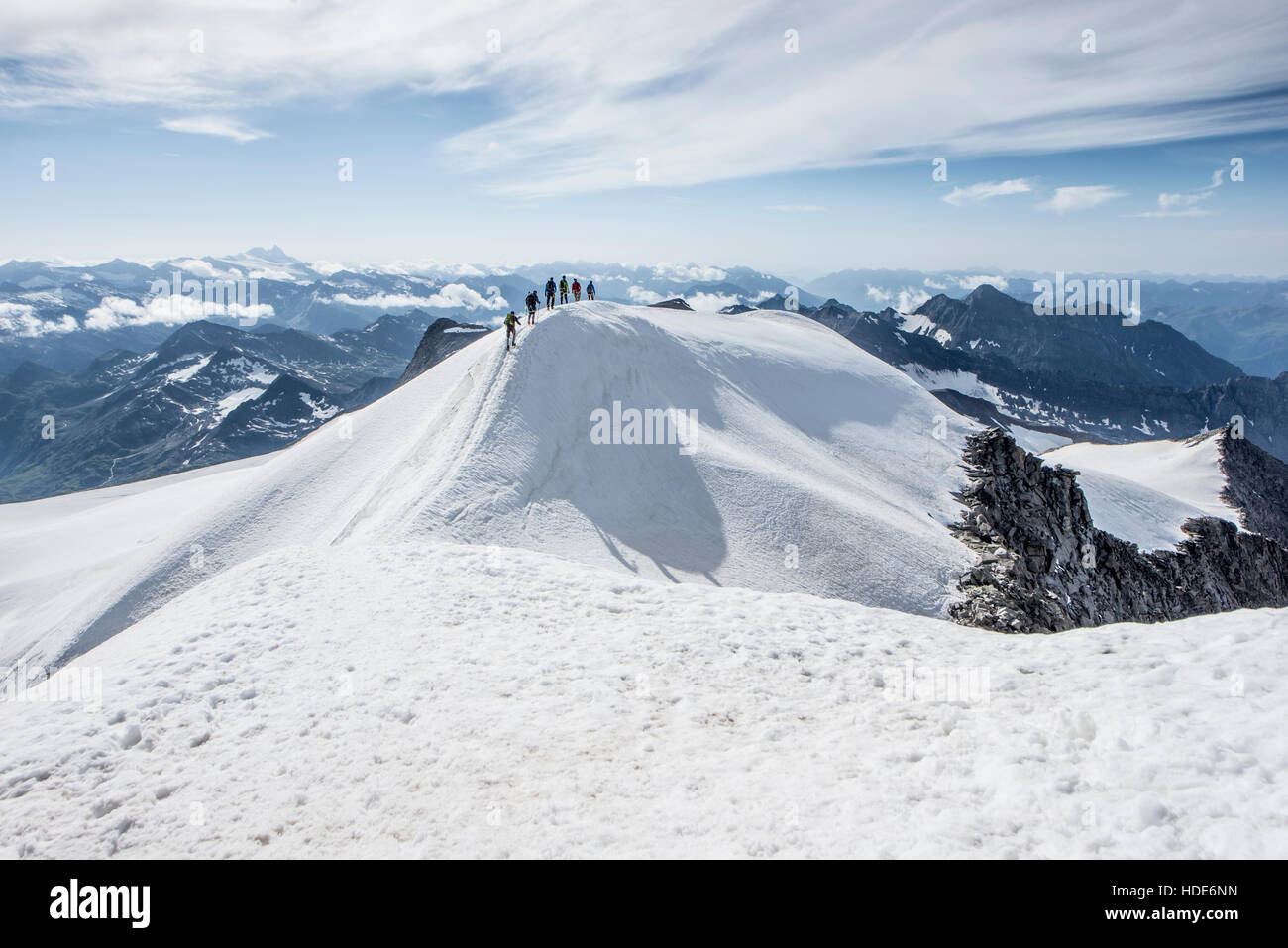 Group of climbers roped together climbing the snowy slope of the ...