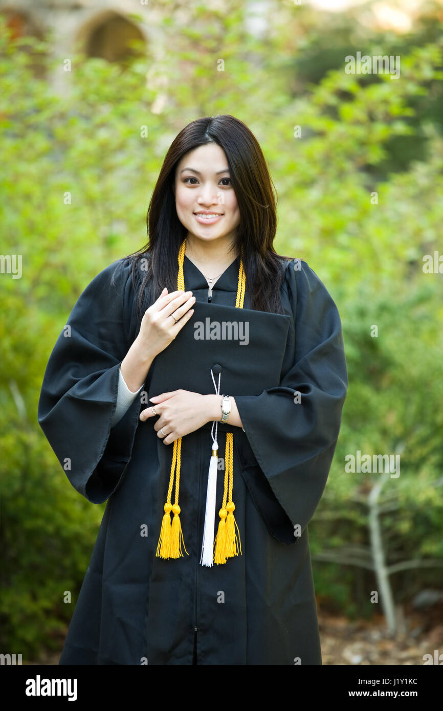 A happy beautiful graduation girl holding the graduation cap Stock ...