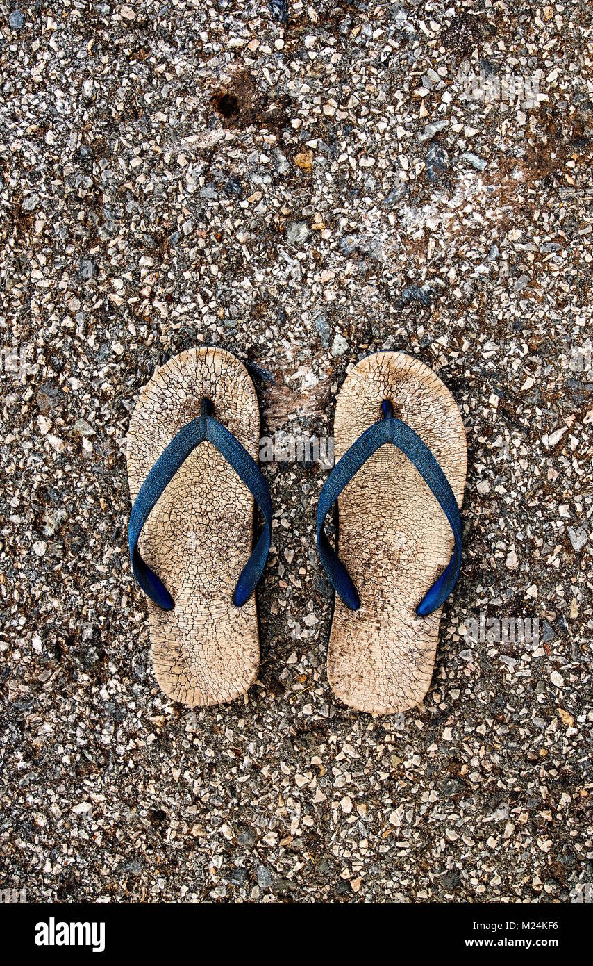 Old Unused Rubber Sandal with Tear and Torn on the Outdoor Concrete ...