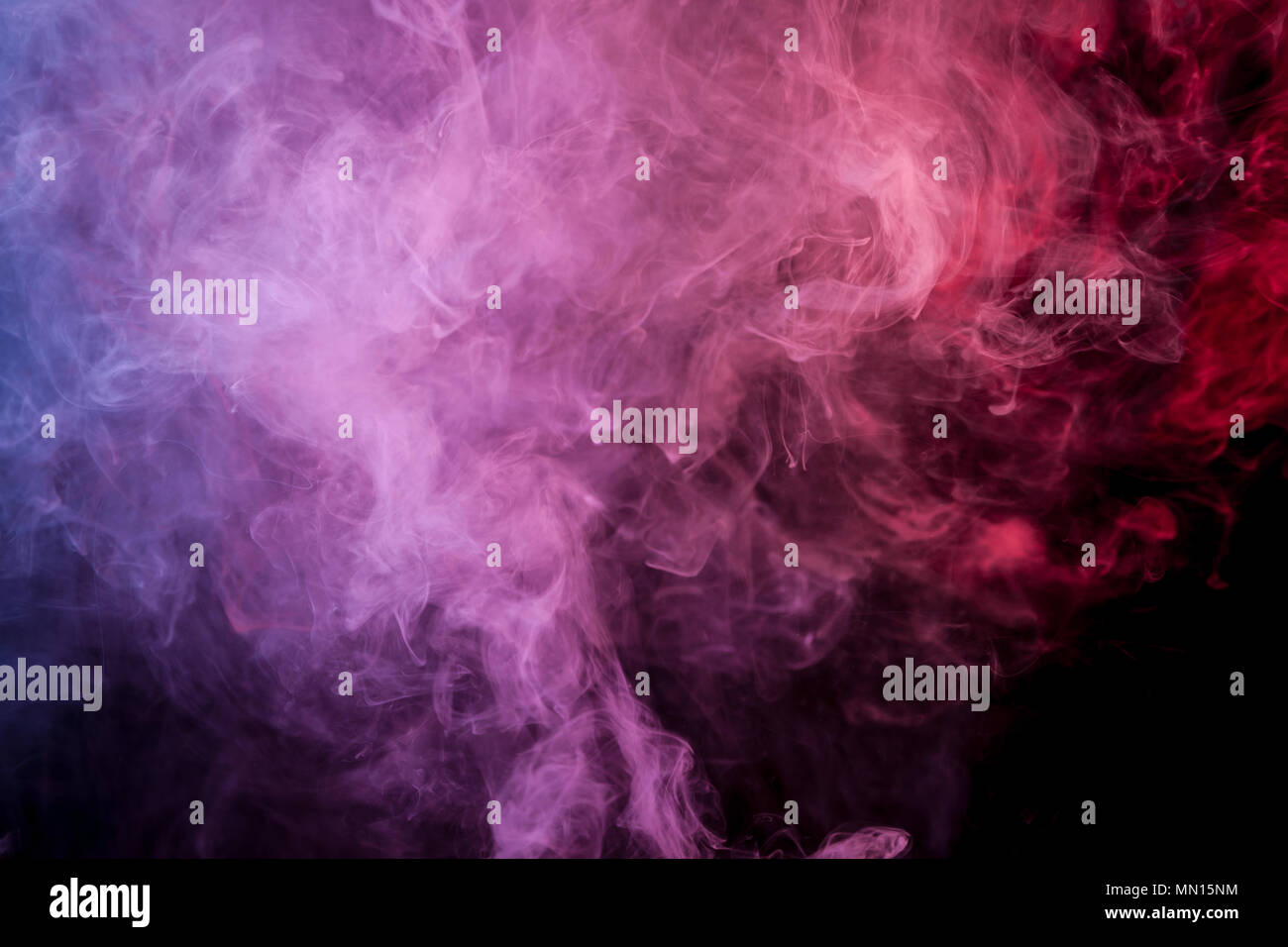 Red, blue and purple cloud of smoke of black isolated background ...