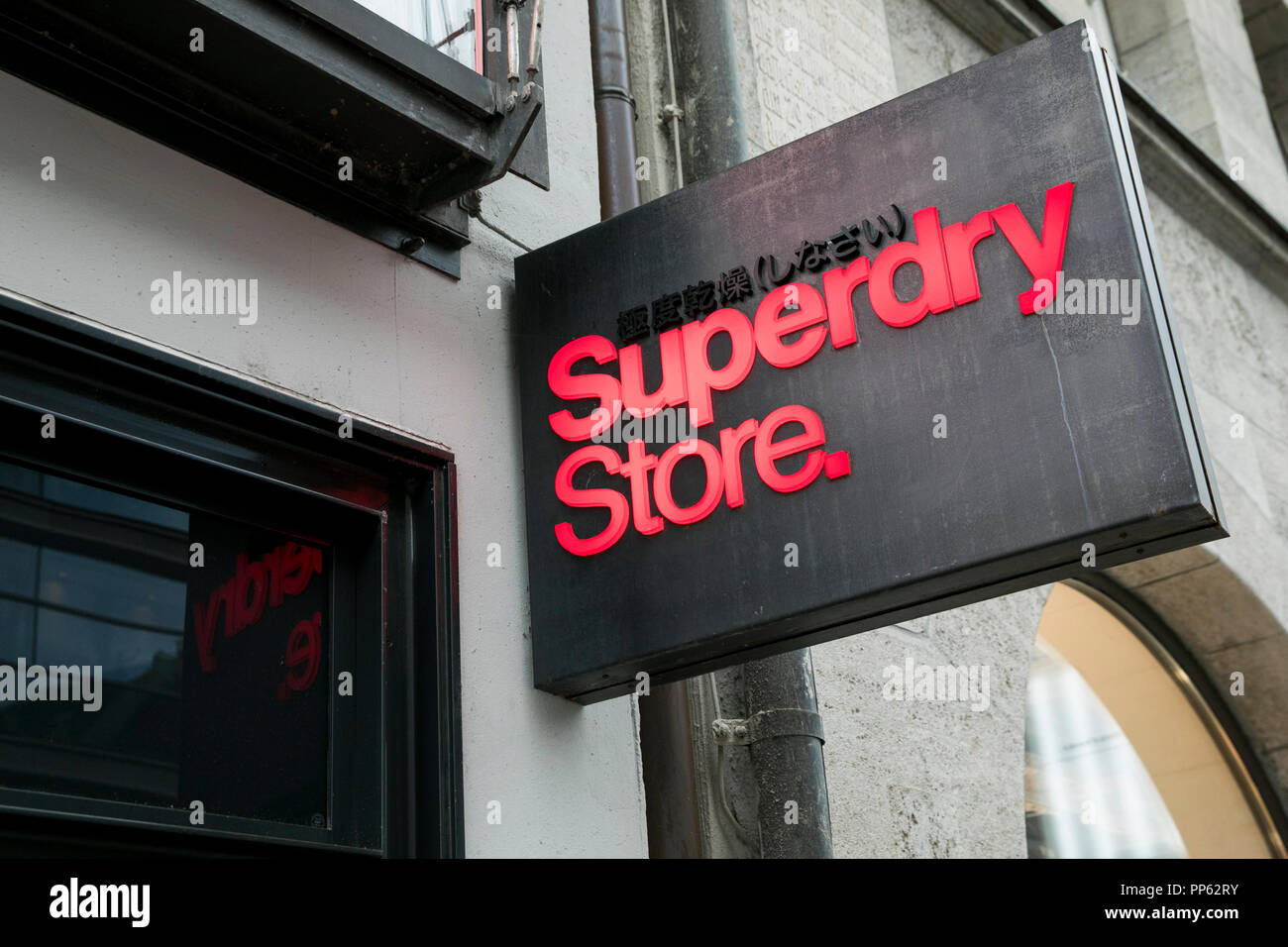A logo  sign outside of a Superdry  retail  store in Munich 