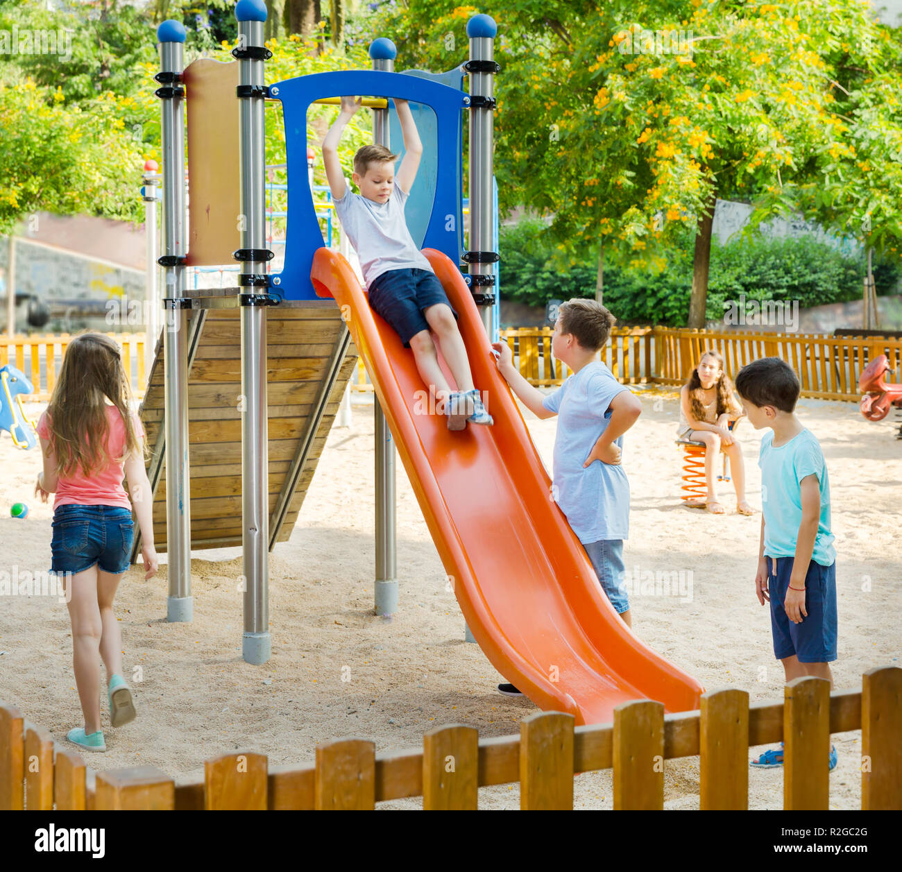 Kids Playing On The Slide At The Playground Stock Photo Alamy