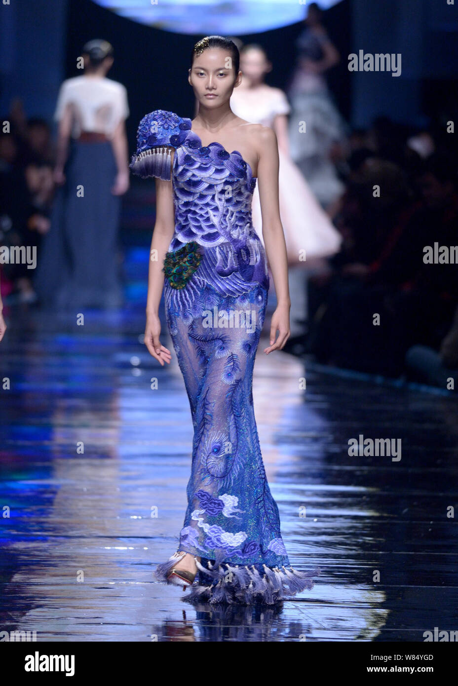 A model displays a new creation by Laurence Xu at a fashion show of ...