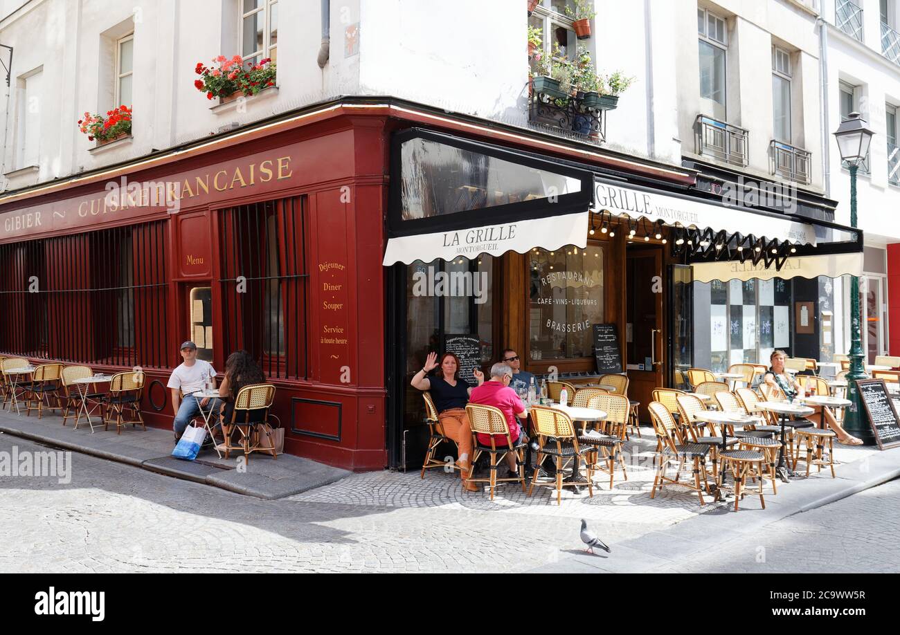 People sitting in a traditional French cafe La Grille Montorgueil on ...