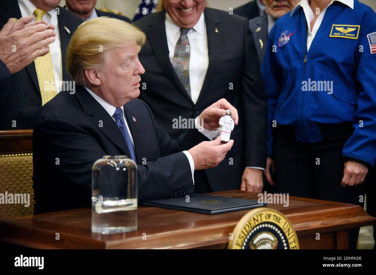 U.S. President Donald Trump holds an astronaut figure given by Apollo ...