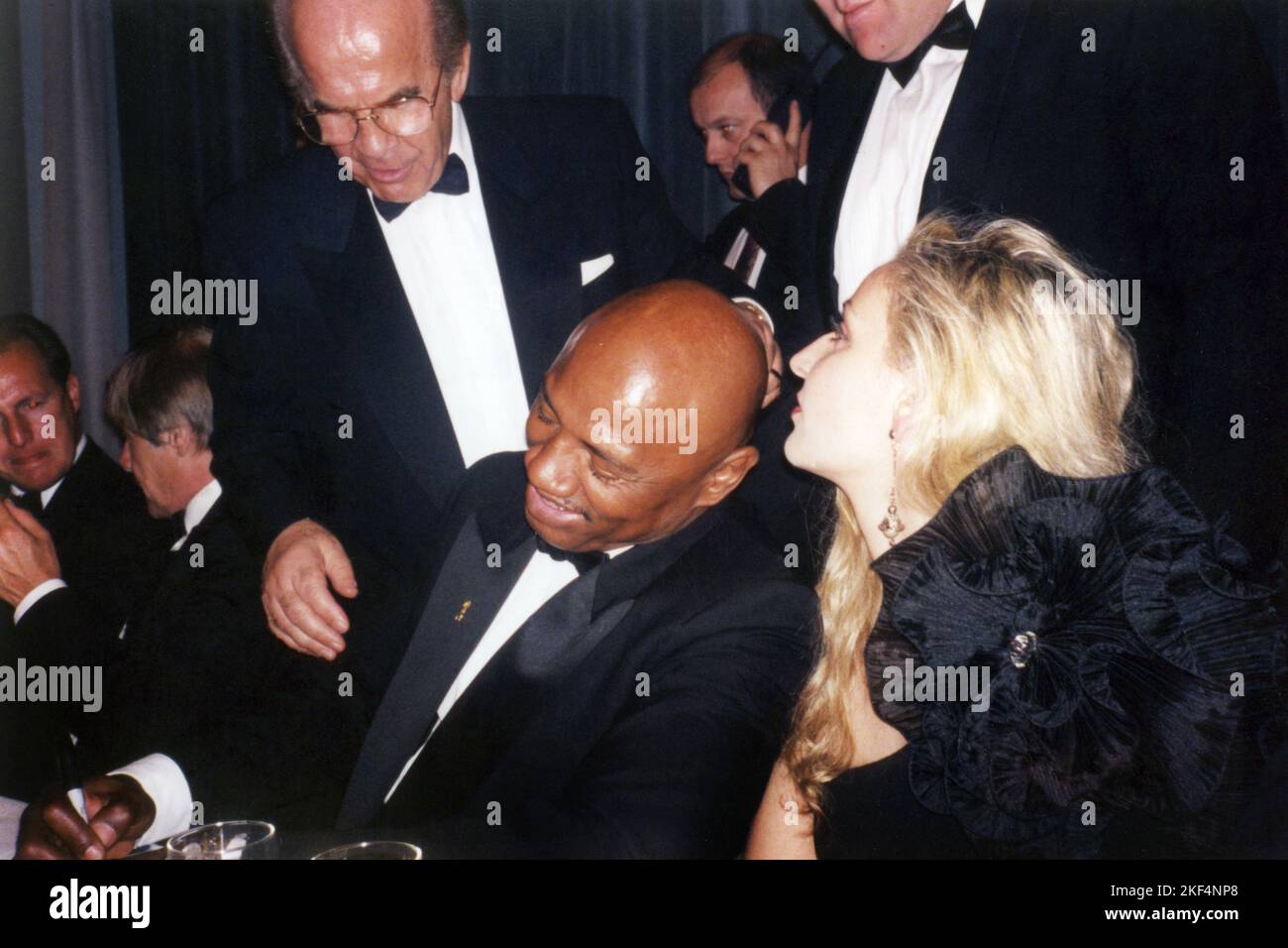 Boxing promoter Mickey Duff looks over the shoulder of former World ...