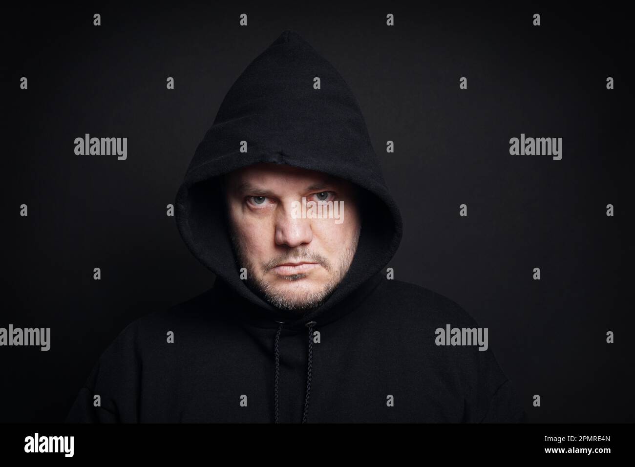 man wearing black hoodie hooligan or gangster concept Stock Photo - Alamy