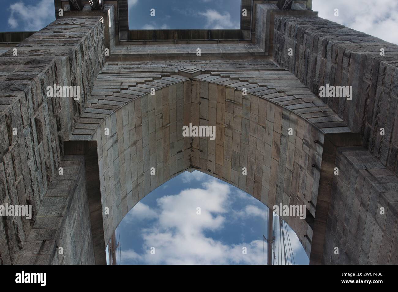 Looking up at a Brooklyn Bridge tower and arch made from limestone and ...