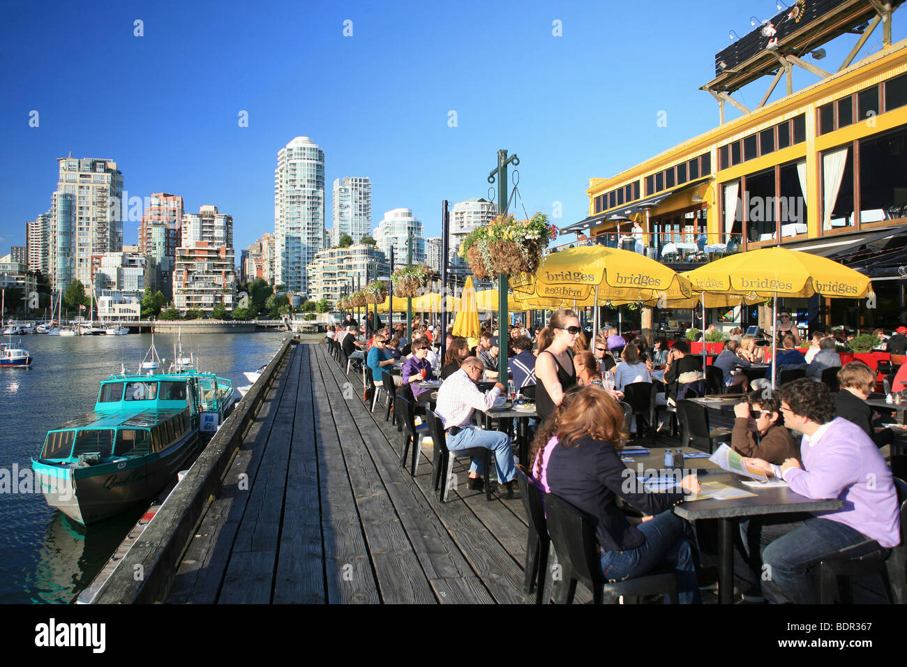 Restaurant in Granville Island and Vancouver Skyline Stock Photo - Alamy