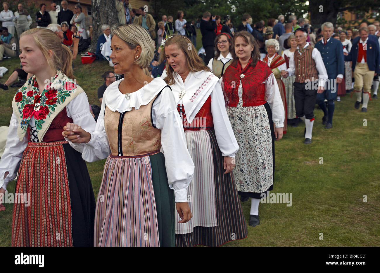 Couples In Traditional Swedish Folk Costumes Parade At Midsummer