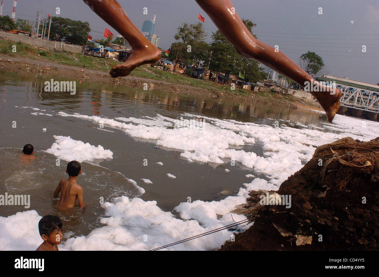 Boys swim in polluted river at slum area in Jakarta Stock 