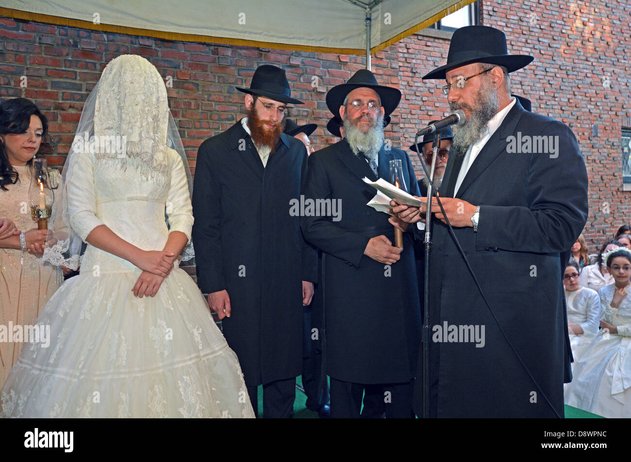 A orthodox religious Jewish bride and groom under a canopy
