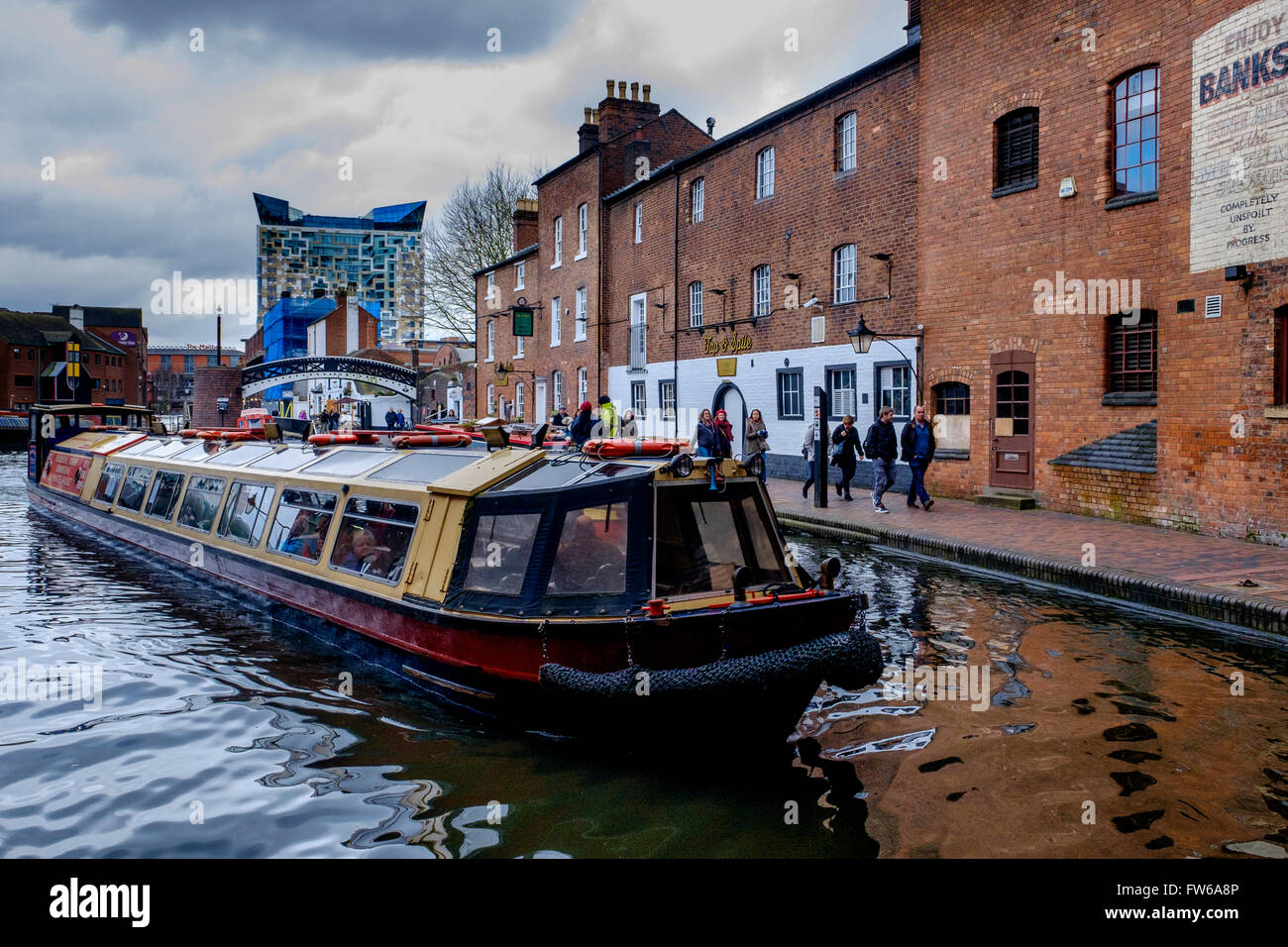 A canal boat on Birmingham Canal Old Line in the centre of the city of
