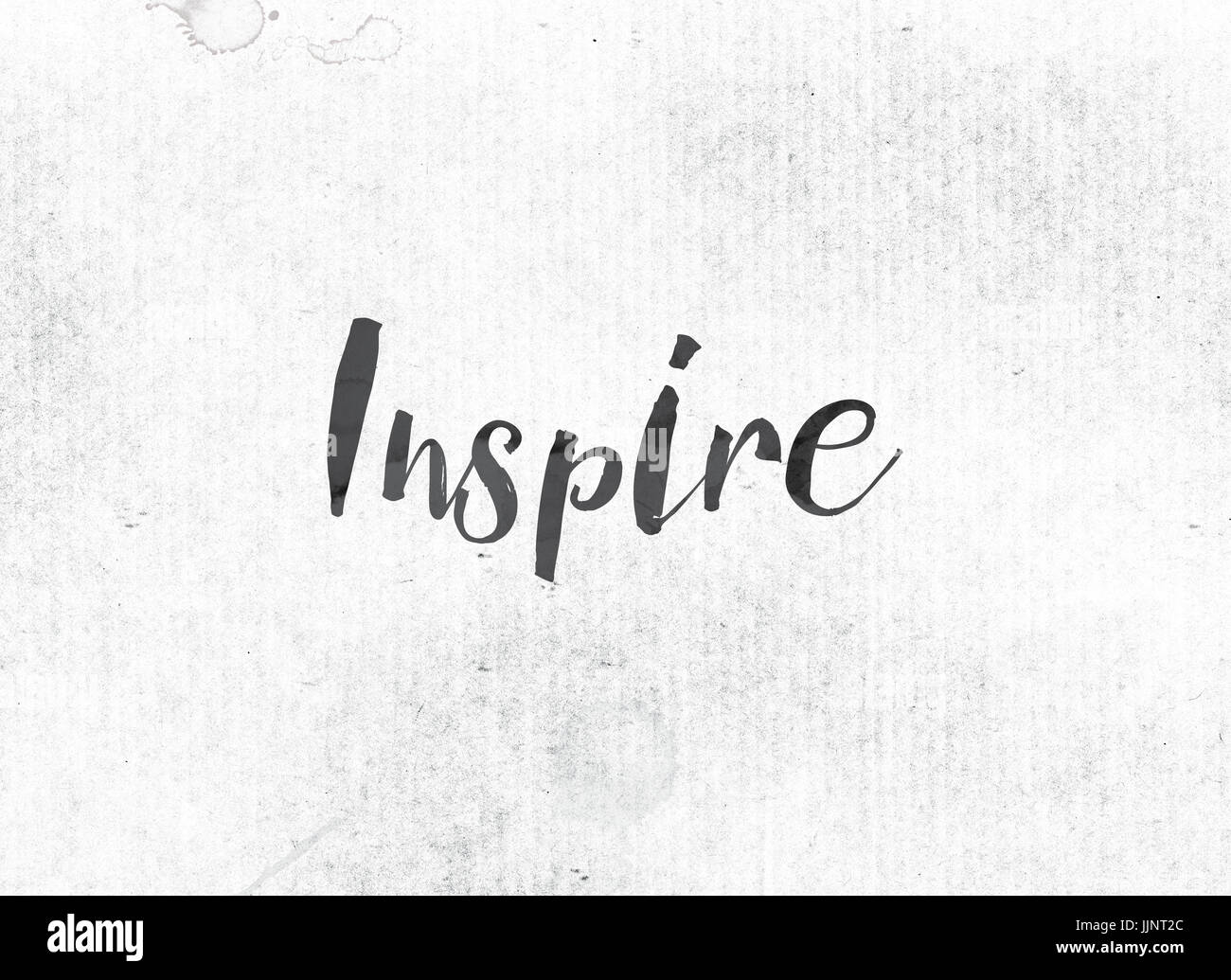 The word Inspire concept and theme painted in black ink on a watercolor ...