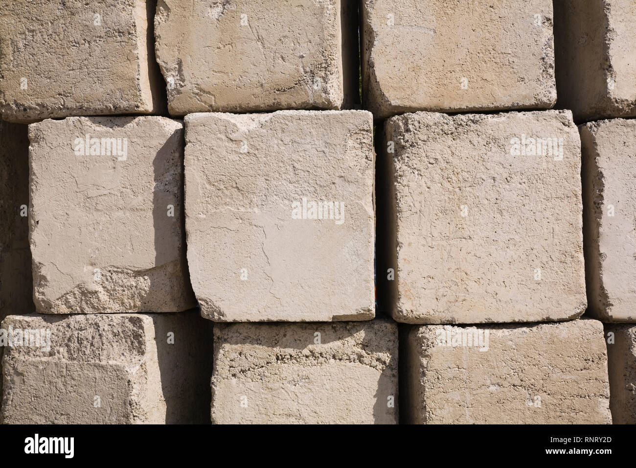 Close-up of large and heavy stacked square shaped concrete blocks Stock