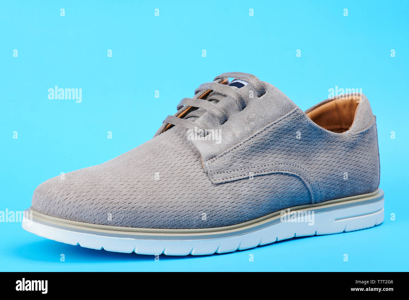 Elegant casual man shoe side view isolated on blue background Stock ...