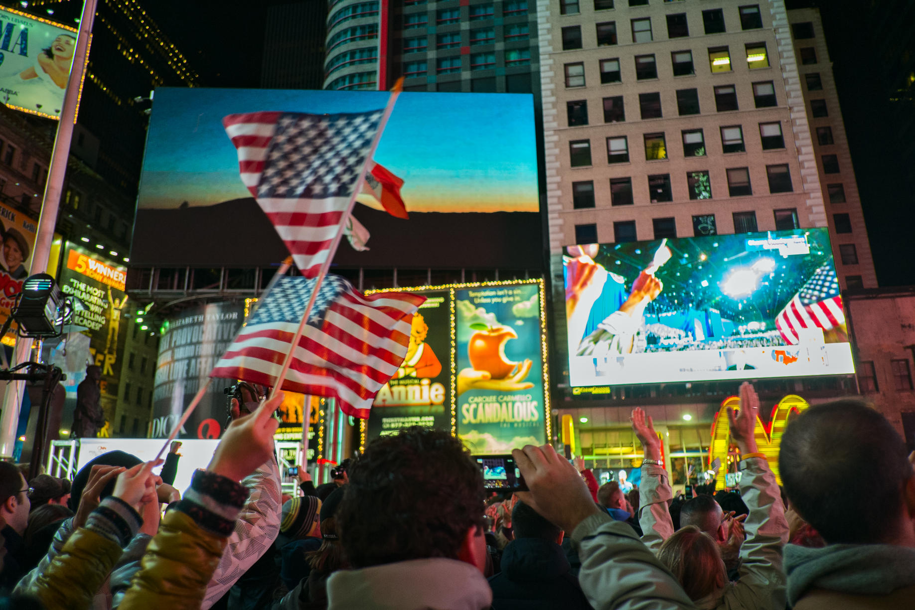 November 7, 2012, New York, NY, US. Crowd in Times Square awaits President Barack Obama's re-election victory speech to be played on giant TV screens.