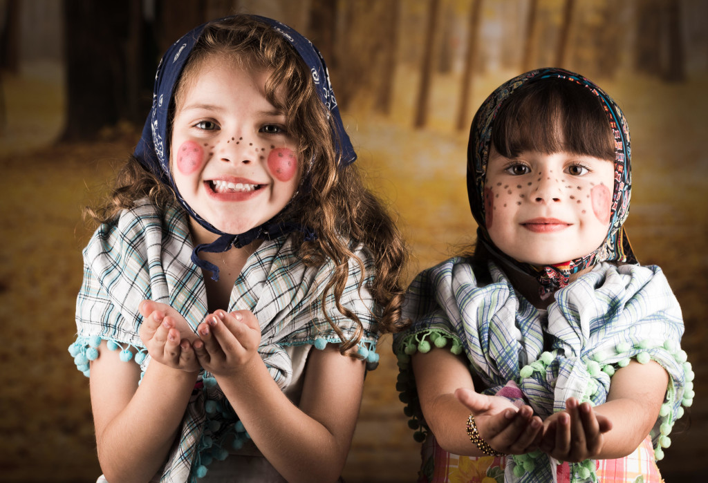 Beautiful little girls dressed as a traditional witches