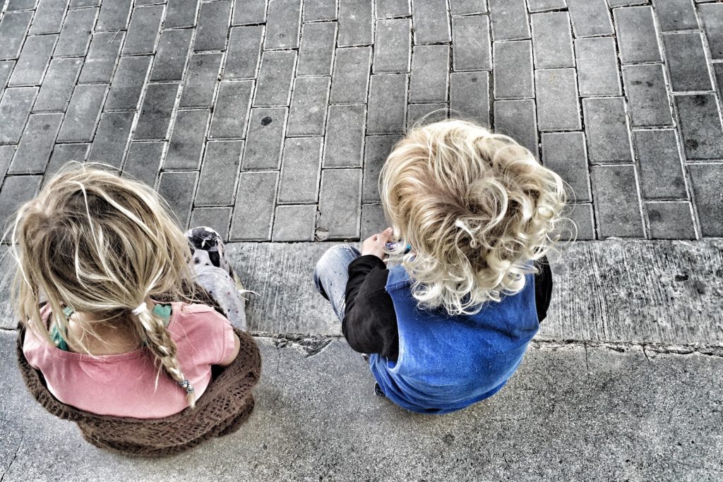 S0X325 2 kids sitting on the pavement
