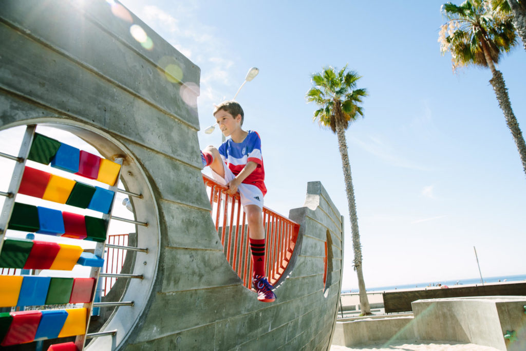 A young boy on the beach playground in Santa Monica, California.